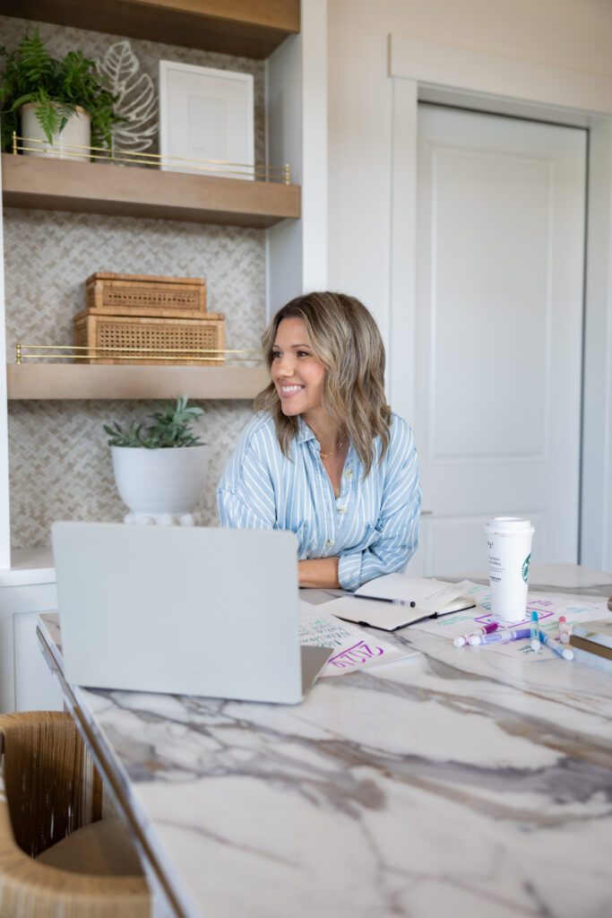 female business coach working on laptop planning strategy