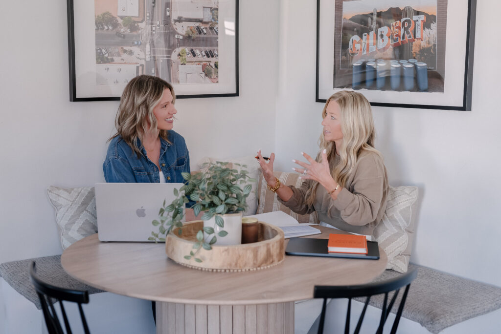 business coaching session helping female founder gain clarity, sitting in person together as her business coach